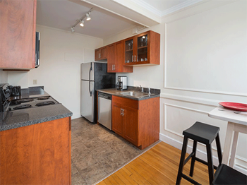 a kitchen with wooden cabinets and a stove and a refrigerator